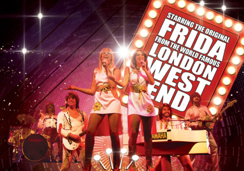 Two women and two men dressed as ABBA performing on stage
